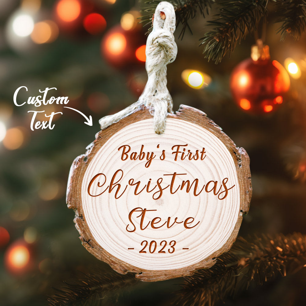 Personalized Baby's First Christmas Ornament with name Steve 2022 on a wooden tree slice. Custom Christmas tree decor.